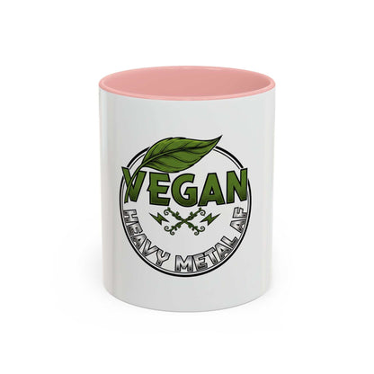 Glossy ceramic coffee mug with Vegan Heavy Metal Logo featuring green leafy text and crossed lightning bolts on white background with colored handle and interior