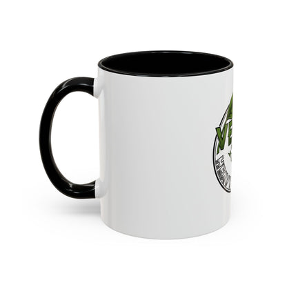 Glossy ceramic coffee mug with vegan heavy metal logo, white exterior, green leafy text, and colored handle, available in 11oz and 15oz sizes