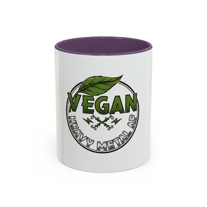 Glossy ceramic coffee mug with Vegan Heavy Metal Logo featuring green leafy letters and crossed lightning bolts, available in 11oz or 15oz with colored interior and handle